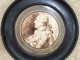 a picture of a woman in a black frame on the floor