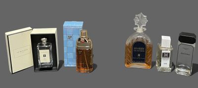 three bottles of perfume sitting next to each other on a table