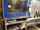 a blue oven that is sitting in a kitchen