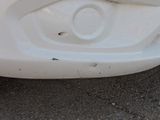 a close up of a car ' s front bumper with a hole in it