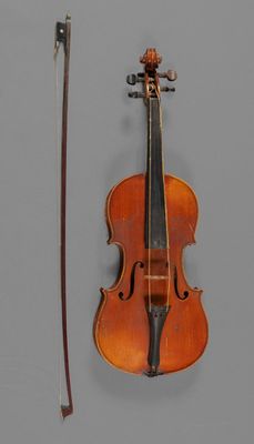 a violin that is sitting next to a bow