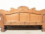 a wooden bench that has chains on the back of it
