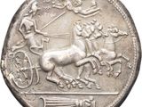an old silver coin with a horse and carriage on it
