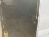 a white van with the door open on the side of the road