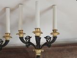 four candles that are sitting on a mantle