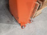 an orange piece of metal sitting on top of a wooden pallet