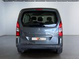a small silver van parked in a garage