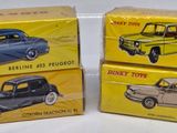 three boxes of toy cars sitting on top of a white surface