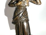 statue of a woman with a bird on her shoulder
