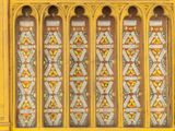 a yellow window with stained glass in it