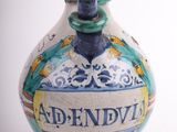 a blue and white vase with a name on it