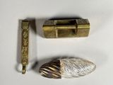 two different types of metal objects on a white surface
