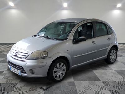 a picture of a silver citrole parked in a garage