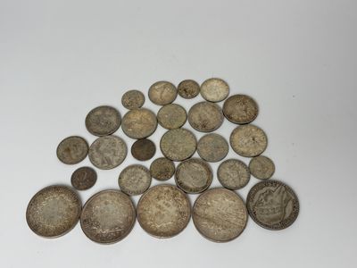 a pile of old coins sitting on top of a white table