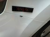 a sticker on the hood of a white car