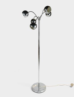 a chrome plated floor lamp with three lights on a metal base