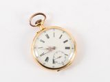 a gold pocket watch with roman numerals on it