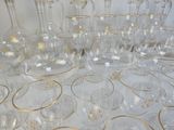 a lot of glasses and vases sitting on a table
