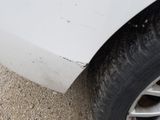 a close up of a car ' s tire with dirt all over it