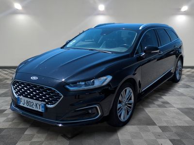 a black ford monde parked on a checkered tile floor