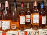 many bottles of wine sitting on a shelf in a store