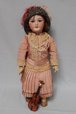 an old doll with a violin and a hat on it