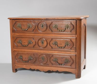 an antique chest of drawers with brass handles and a wooden top