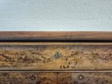 a close up of a wooden drawer with a clock on it