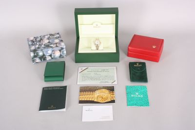 a box with a watch and other items on a table