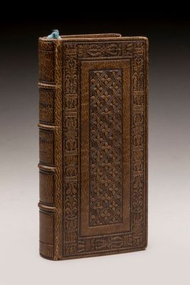 an old book with a bird on top of it