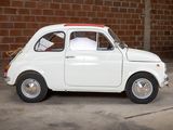 a small white car that is parked in a garage