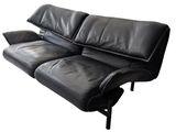 the black leather sofa is sitting on a white background