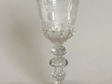 a wine glass sitting on a table with a white background