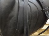 a close up of a horse ' s saddle on a wooden platform