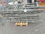 a large pile of metal pipes sitting on a pallet