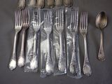 a lot of silver spoons and forks on the table