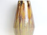 a vase that is sitting on a white surface