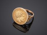 a gold coin ring with a woman ' s face on it