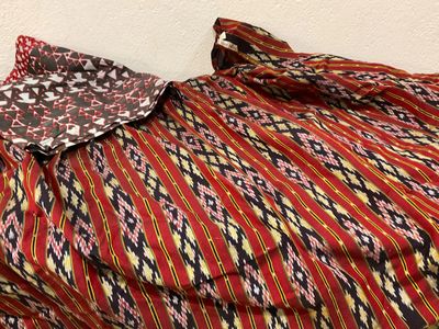 an image of a red and black dress with a pattern on it