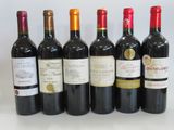 several bottles of wine are lined up on a table