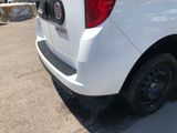 the back end of a white truck parked in a parking lot