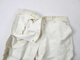 an image of a pair of white shorts with a zipper on the side