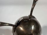 a silver spoon with a spoon sticking out of it