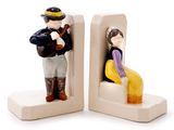 two figurines of a man and a woman sitting on a bench