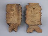 two pieces of wood are sitting next to each other on a table