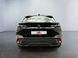 the rear end of a black car in a white room
