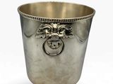 an image of a silver cup with a lion head on it