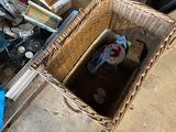 a wicker basket with a bottle of water inside of it