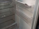 a white refrigerator with its door open and a freezer door open