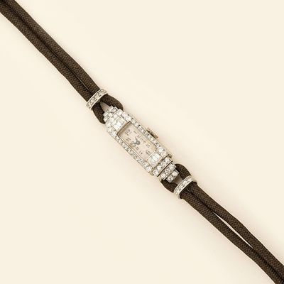 an image of a wrist watch with diamonds on a black cord